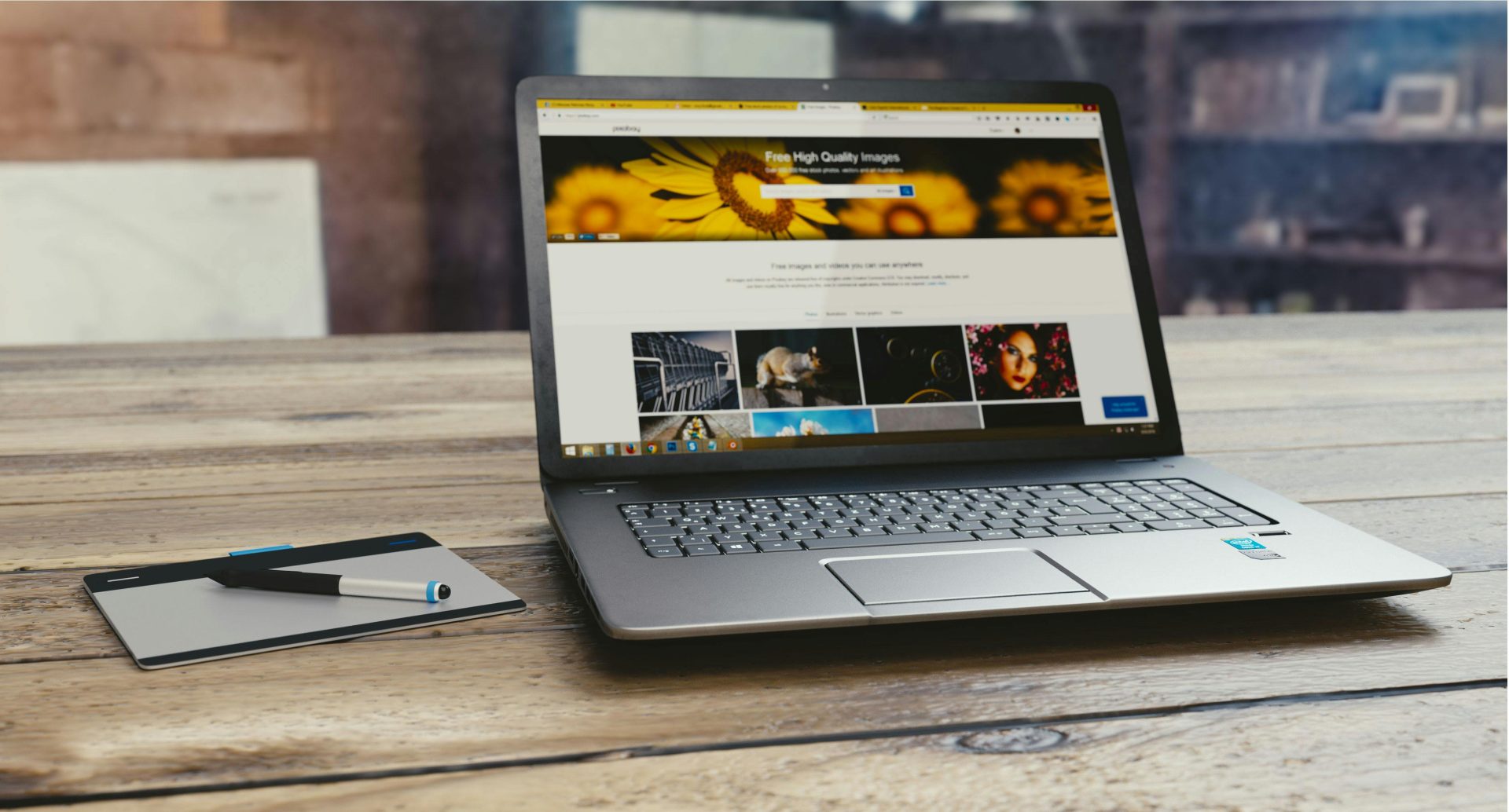 pexels-photo-109371-109371 Laptop with open webpage on wooden desk, accompanied by tablet and pen, representing digital work setup.